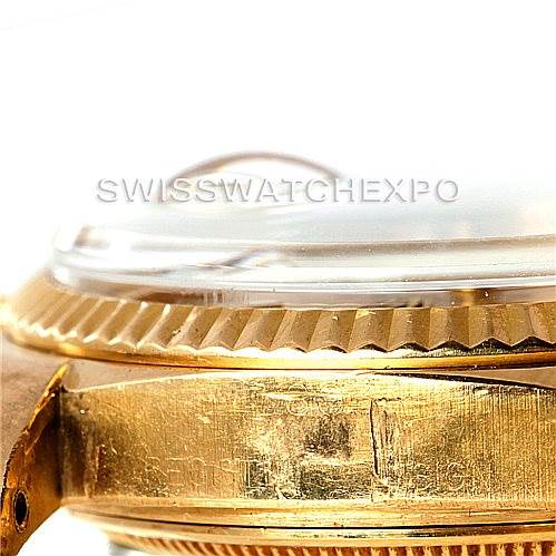 The image shows a close-up, side view of the Rolex President 1803 Men
s Yellow Gold Champagne Dial 1803 Men
s Yellow Gold Champagne Dial model focusing on its bezel, crystal, and part of the gold case.