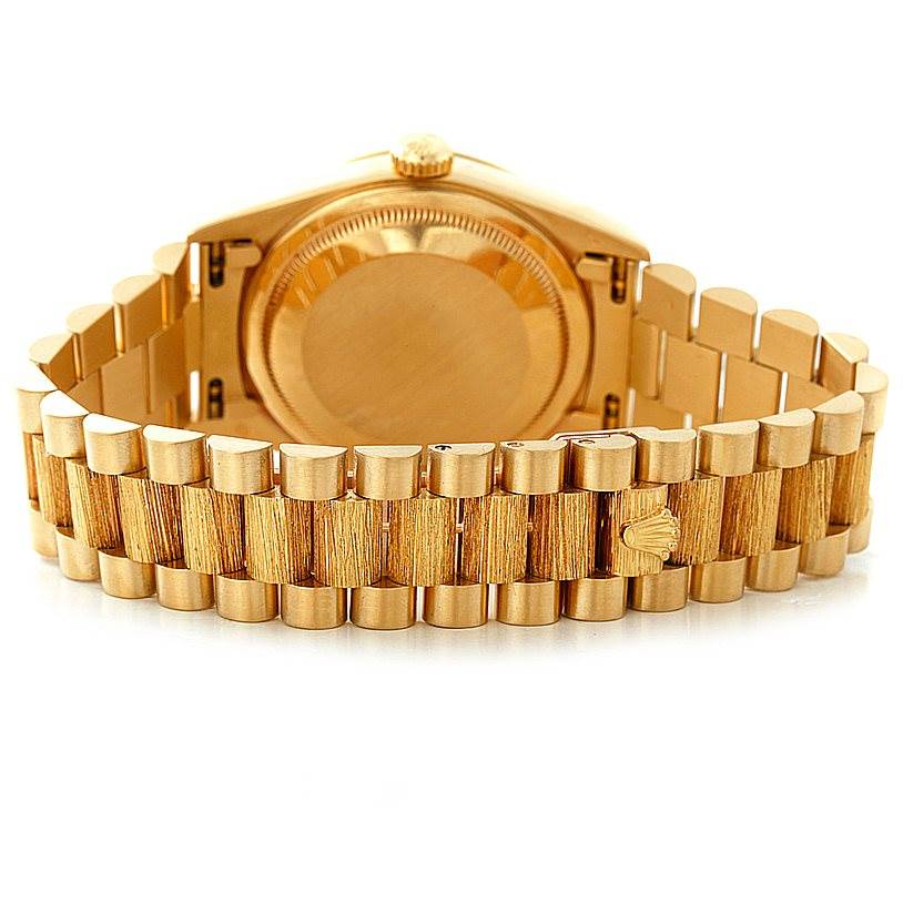 The image shows the back of a Rolex President 18248 Men's Yellow Gold Blue Dial 18248 Men's Yellow Gold Blue Dial watch, highlighting its gold bezel and bracelet.