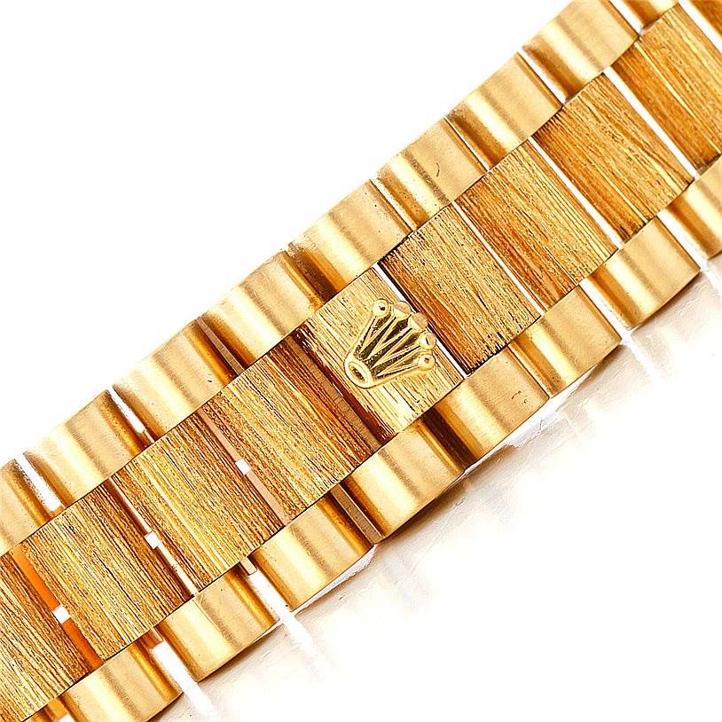 This image shows a close-up of the gold bracelet of a Rolex President 18248 Men's Yellow Gold Blue Dial 18248 Men's Yellow Gold Blue Dial model watch, featuring the iconic Rolex crown logo.