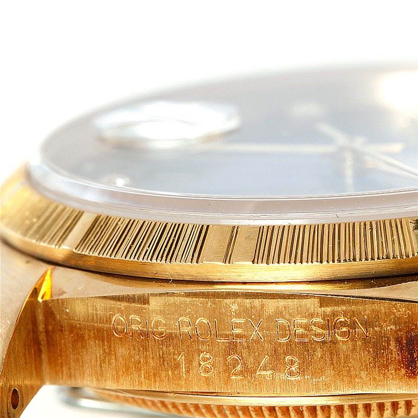 The image shows a close-up angle of the Rolex President 18248 Men's Yellow Gold Blue Dial 18248 Men's Yellow Gold Blue Dial model watch, highlighting the bezel, partial dial, and engraved case.