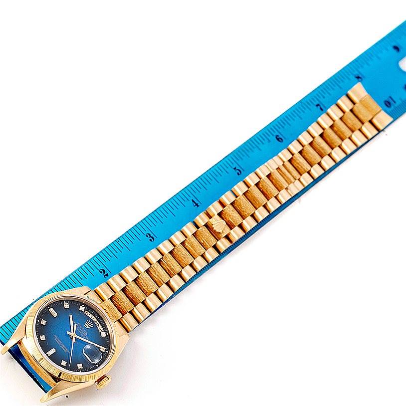 The image shows a Rolex President 18248 Men's Yellow Gold Blue Dial 18248 Men's Yellow Gold Blue Dial model watch with a blue dial and gold bracelet next to a blue ruler for scale.
