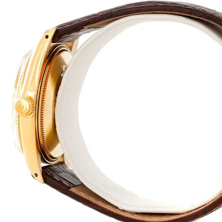 The image shows a side view of the Rolex President 1503 Men
s Yellow Gold Champagne Dial 1503 Men
s Yellow Gold Champagne Dial model watch, showcasing its crown and part of the leather strap.