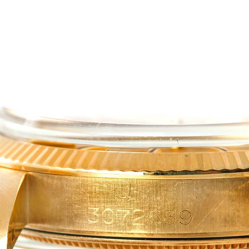 The image shows a close-up of the case side, bezel, and part of the crystal of a Rolex President 1503 Men
s Yellow Gold Champagne Dial 1503 Men
s Yellow Gold Champagne Dial model, highlighting its serial number.