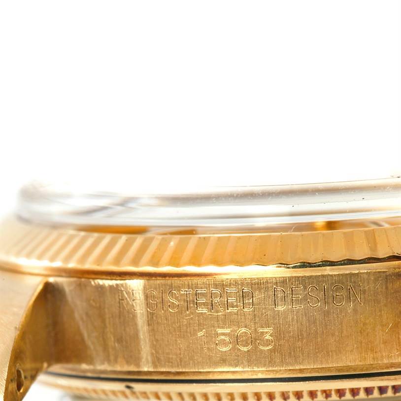 This close-up image shows the side view of the bezel and case of a Rolex President 1503 Men
s Yellow Gold Champagne Dial 1503 Men
s Yellow Gold Champagne Dial model, with "REGISTERED DESIGN 1503" engraved.