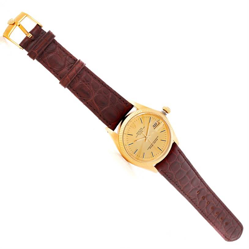 This image shows a Rolex President 1503 Men
s Yellow Gold Champagne Dial 1503 Men
s Yellow Gold Champagne Dial watch model at a top-down angle, featuring its face and entire leather strap.