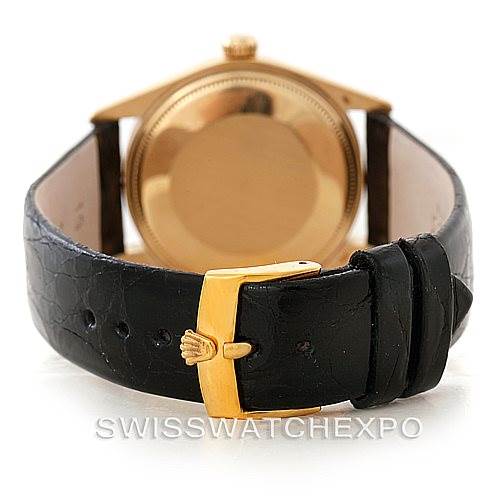 This image shows the back of a Rolex President 1503 Men's Yellow Gold White Dial 1503 Men's Yellow Gold White Dial model watch, focusing on its black leather strap and gold buckle.