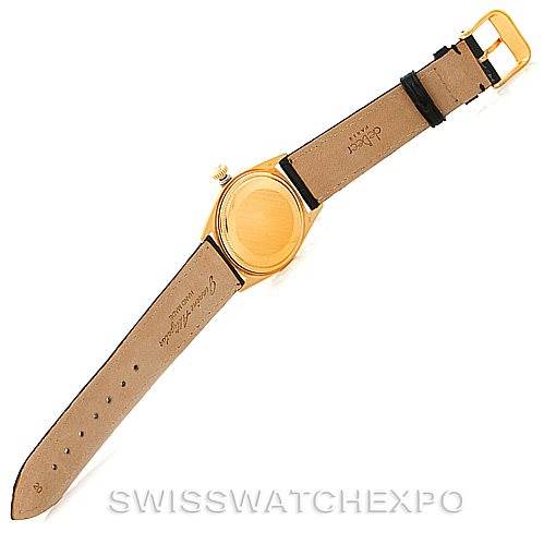 This image shows the back view of a Rolex President 1803 Men
s Yellow Gold Black Dial 1803 Men
s Yellow Gold Black Dial model watch with a leather strap and a gold case.