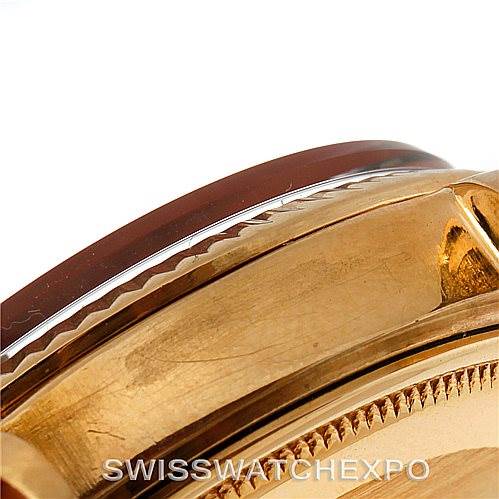 This image shows a close-up side view of the bezel and part of the case of a Rolex President 1803 Men
s Yellow Gold Black Dial 1803 Men
s Yellow Gold Black Dial model watch.