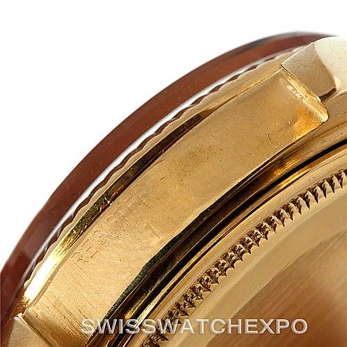 The image shows a close-up of the case and bezel of a Rolex President 1803 Men
s Yellow Gold Black Dial 1803 Men
s Yellow Gold Black Dial model watch at an angle, highlighting its gold finish.