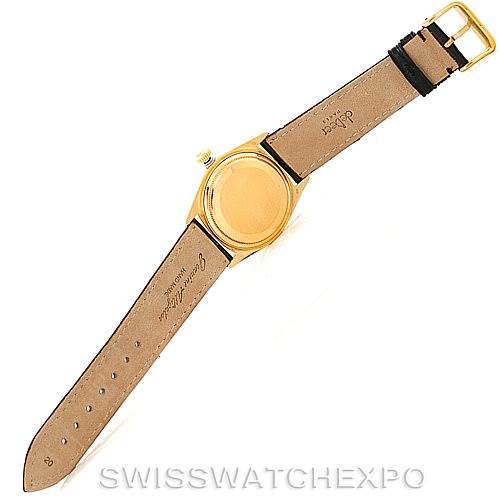 The image shows the back of a Rolex President 18038 Men's Yellow Gold Black Dial 18038 Men's Yellow Gold Black Dial model watch with its leather strap fully extended, displaying the case back and buckle.