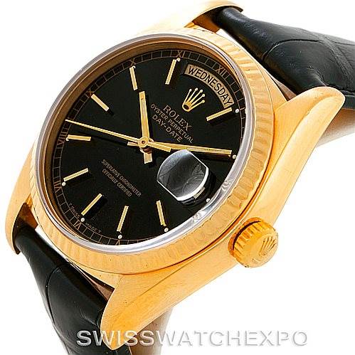 The image shows a President model Rolex watch at an angled view, highlighting its black dial, gold case, day-date window, and leather strap.