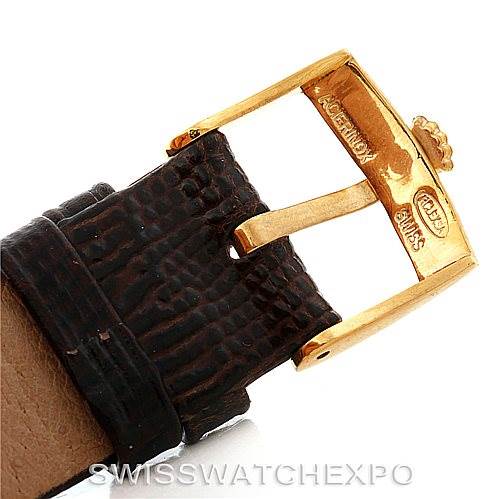 The image shows a close-up of the Rolex President 1601 Men
s Yellow Gold Champagne Dial 1601 Men
s Yellow Gold Champagne Dial model
s buckle and a portion of the leather strap.