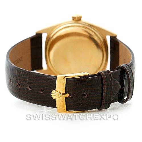 The image shows a Rolex President 1601 Men
s Yellow Gold Champagne Dial 1601 Men
s Yellow Gold Champagne Dial model watch from the back, highlighting its leather strap and buckle.