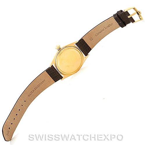 This image shows the back case and leather strap of a Rolex President 1601 Men
s Yellow Gold Champagne Dial 1601 Men
s Yellow Gold Champagne Dial model watch laid flat.