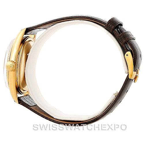 The image shows a side view of the Rolex President 1601 Men
s Yellow Gold Champagne Dial 1601 Men
s Yellow Gold Champagne Dial model watch, highlighting its gold case and brown leather strap.