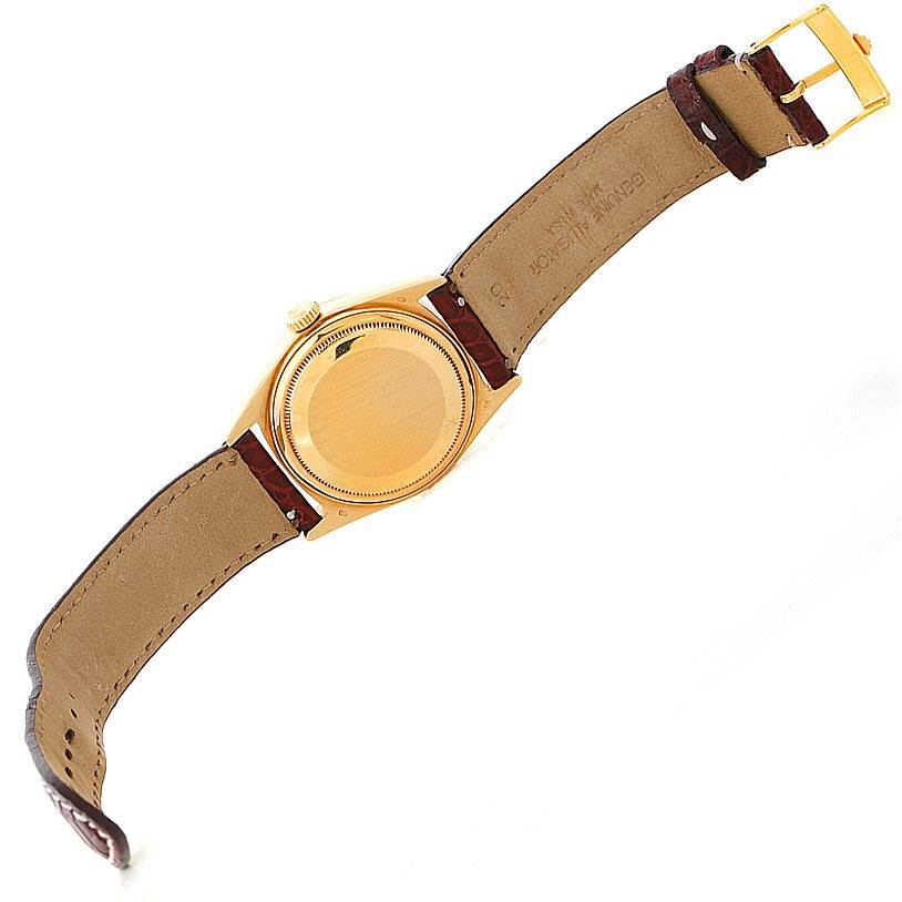 This image shows the back and sides of the Rolex President 18038 Men
s Yellow Gold Champagne Dial 18038 Men
s Yellow Gold Champagne Dial model watch, including its leather strap and gold caseback.