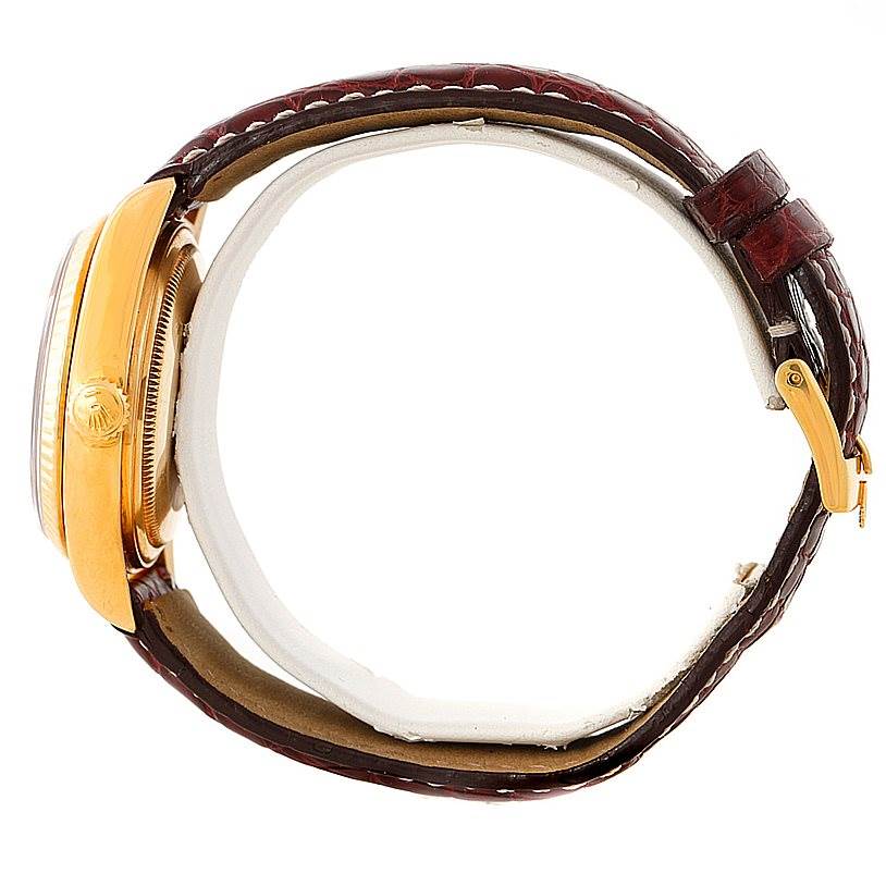 The image shows a side view of a Rolex President 18038 Men
s Yellow Gold Champagne Dial 18038 Men
s Yellow Gold Champagne Dial model watch with a brown leather strap and a gold case.