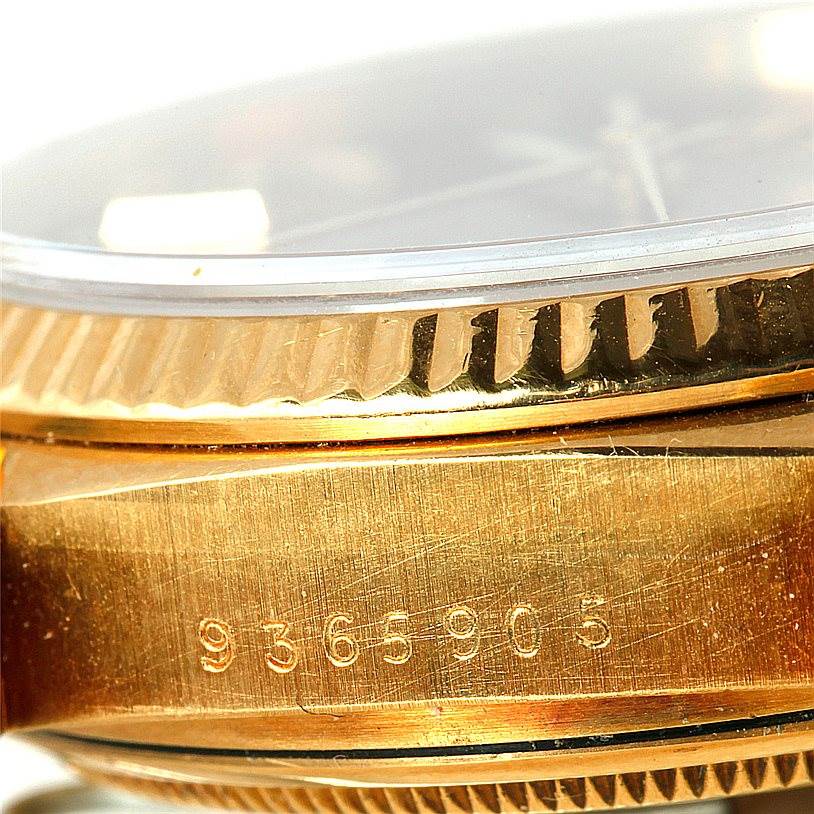 This close-up image shows the side of a Rolex President 18038 Men
s Yellow Gold Champagne Dial 18038 Men
s Yellow Gold Champagne Dial watch, focusing on the gold case and the serial number.
