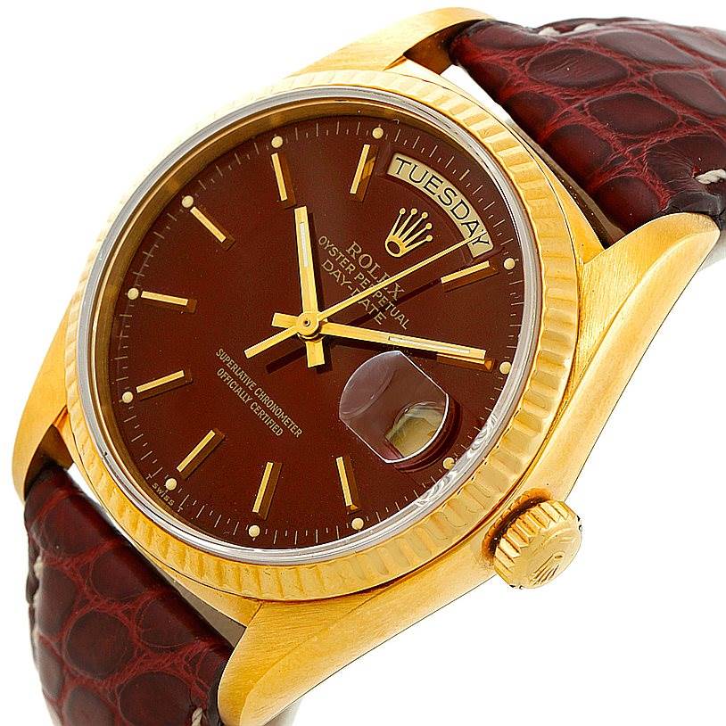 The image shows a close-up of a Rolex President 18038 Men
s Yellow Gold Champagne Dial 18038 Men
s Yellow Gold Champagne Dial watch, featuring its dial, day-date window, and brown leather strap.