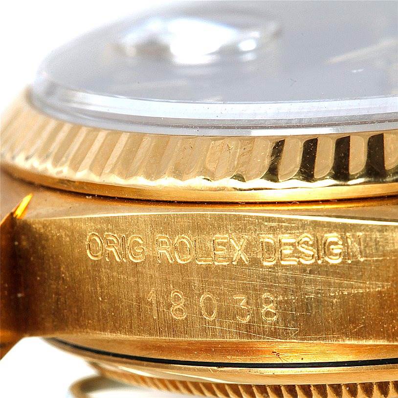 This image shows a close-up of the case side and bezel of a Rolex President 18038 Men
s Yellow Gold Champagne Dial 18038 Men
s Yellow Gold Champagne Dial model with the engraving "ORIG ROLEX DESIGN" and model number "18038."