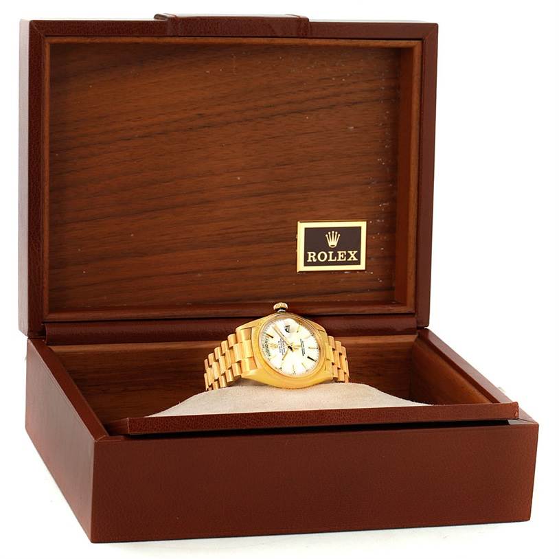 The Rolex President 1807 Men
s Yellow Gold Silver Dial 1807 Men
s Yellow Gold Silver Dial watch is displayed in an open wooden Rolex box, viewed from the front.