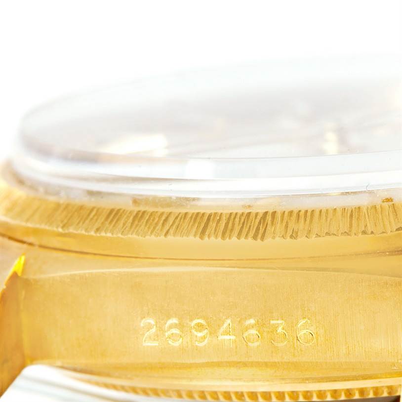 This image shows a close-up of the Rolex President 1807 Men
s Yellow Gold Silver Dial 1807 Men
s Yellow Gold Silver Dial model
s side, highlighting the serial number and part of the crystal.