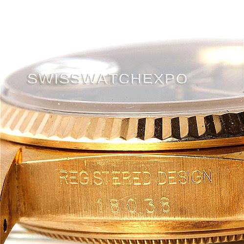 The image shows a close-up of the side of a Rolex President 18038 Men's Yellow Gold Black Dial 18038 Men's Yellow Gold Black Dial watch, highlighting the bezel and "Registered Design" engraving.