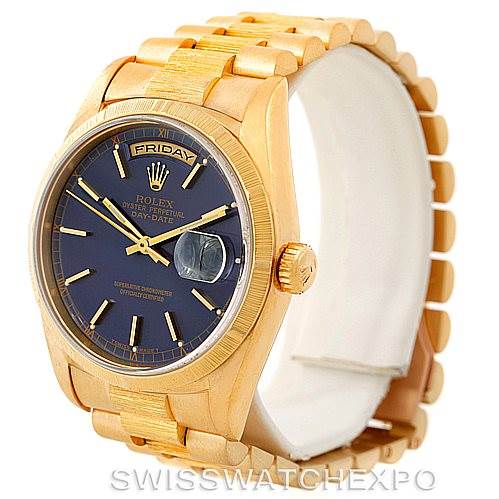 The image shows a Rolex President 18248 Men's Yellow Gold Blue Dial 18248 Men's Yellow Gold Blue Dial model watch at a 3/4 angle, highlighting its gold band, black dial with day-date function, and cyclops lens.