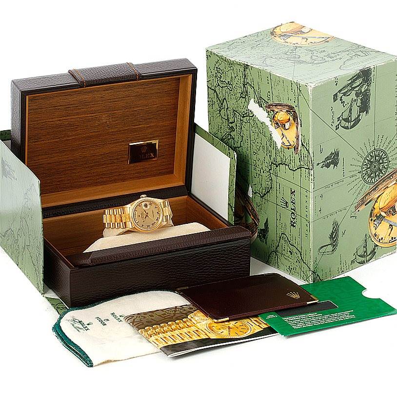 The image shows a Rolex President 18248 Men
s Yellow Gold Champagne Dial 18248 Men
s Yellow Gold Champagne Dial model watch from the front, along with its packaging and accessories, including a box and booklets.