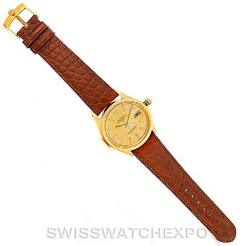 This image shows a top-down view of a Rolex President 1501 Men
s Yellow Gold Champagne Dial 1501 Men
s Yellow Gold Champagne Dial model watch with its gold case and brown leather strap.