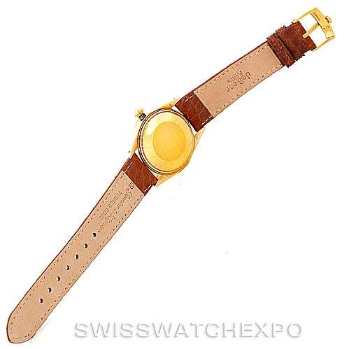 This image shows the back view of a Rolex President 1501 Men
s Yellow Gold Champagne Dial 1501 Men
s Yellow Gold Champagne Dial model watch, highlighting the leather strap and the case back.
