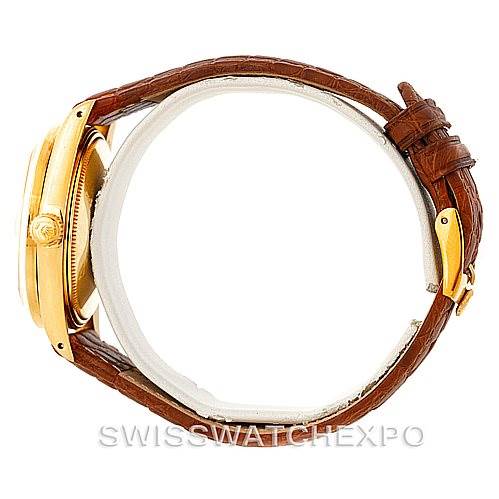 The image shows a side view of a Rolex President 1501 Men
s Yellow Gold Champagne Dial 1501 Men
s Yellow Gold Champagne Dial watch with a brown leather strap and gold case.