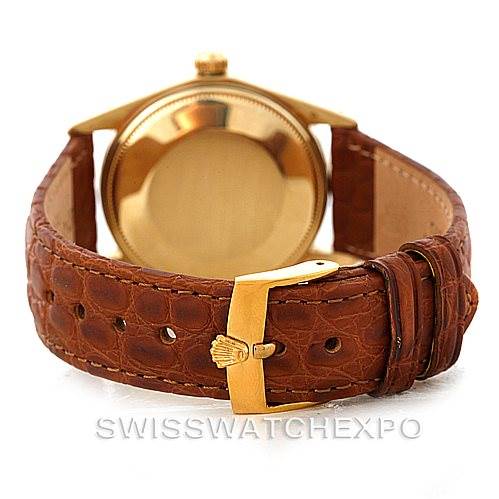 This image shows the back case and strap of a Rolex President 1501 Men
s Yellow Gold Champagne Dial 1501 Men
s Yellow Gold Champagne Dial model watch, featuring a brown leather band and gold clasp.