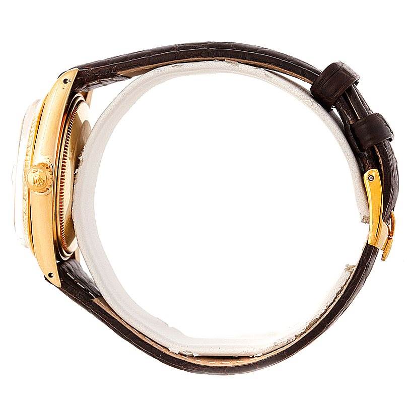 This image shows a side view of a Rolex President 1503 Men
s Yellow Gold Silver Dial 1503 Men
s Yellow Gold Silver Dial model watch, highlighting the case, crown, and leather strap with the buckle.