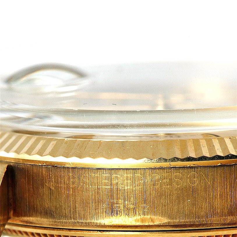 The image shows a close-up of the side of a gold Rolex President 1503 Men
s Yellow Gold Silver Dial 1503 Men
s Yellow Gold Silver Dial watch, highlighting the "REGISTERED DESIGN" engraving and model number 1503.