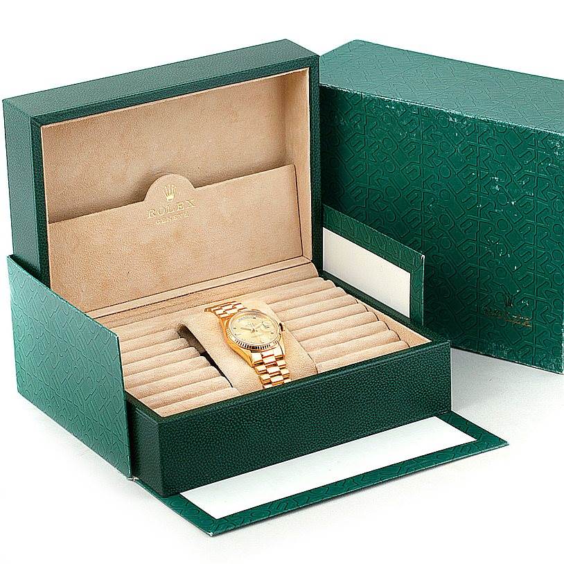 The image shows a Rolex President 18238 Men
s Yellow Gold Champagne Dial 18238 Men
s Yellow Gold Champagne Dial model watch presented in an open green and beige Rolex box.