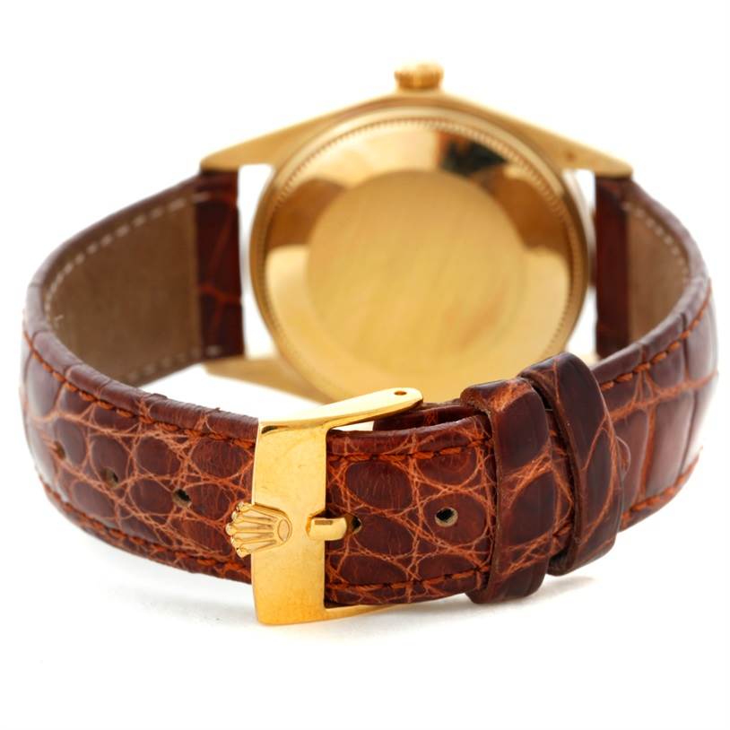 The image shows the back case and leather strap of a Rolex President 1503 Men
s Yellow Gold Champagne Dial 1503 Men
s Yellow Gold Champagne Dial model with a focus on the clasp and buckle.