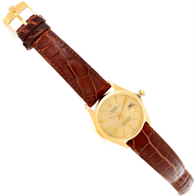 The image shows a Rolex President 1503 Men
s Yellow Gold Champagne Dial 1503 Men
s Yellow Gold Champagne Dial model watch from a top-down angle, displaying its gold case, dial, and brown leather strap.