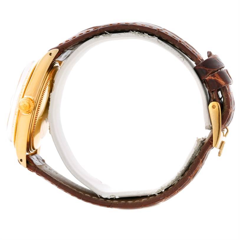 The image shows a side view of a Rolex President 1503 Men
s Yellow Gold Champagne Dial 1503 Men
s Yellow Gold Champagne Dial model watch, highlighting the gold case, crown, and brown leather strap with buckle.