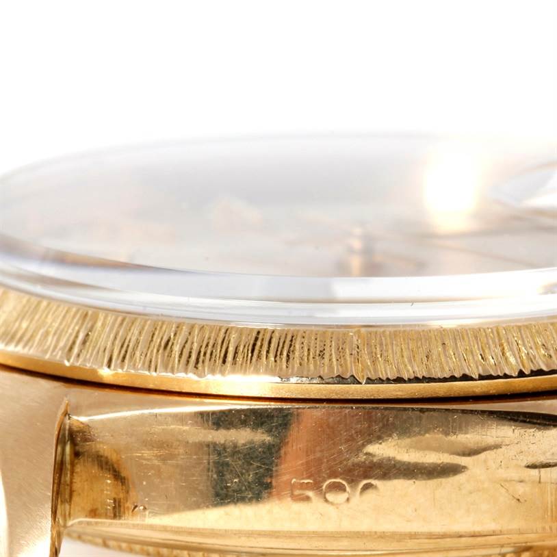 This image shows a close-up angled view of the bezel, crystal, and part of the gold case of the Rolex President 1803 Men
s Yellow Gold Silver Dial 1803 Men
s Yellow Gold Silver Dial model watch.