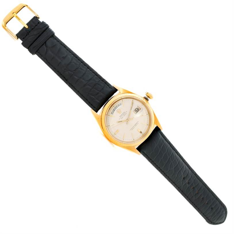 The Rolex President 1803 Men
s Yellow Gold Silver Dial 1803 Men
s Yellow Gold Silver Dial model watch is shown from a top-down angle, displaying the face, dial, crown, and leather strap.