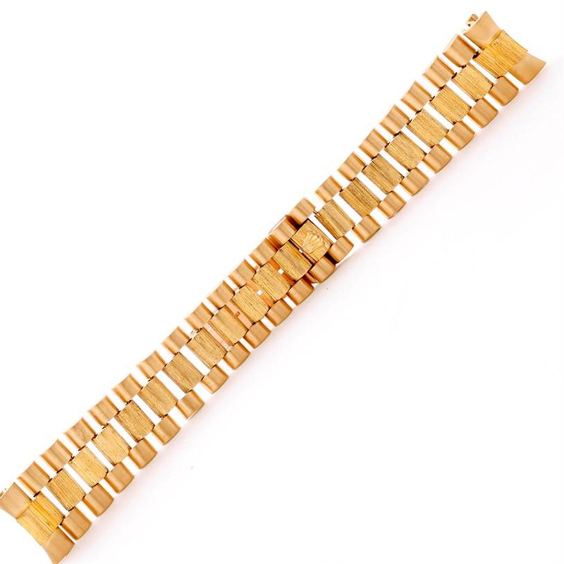 This image shows a close-up of the gold bracelet strap from the Rolex President model watch.
