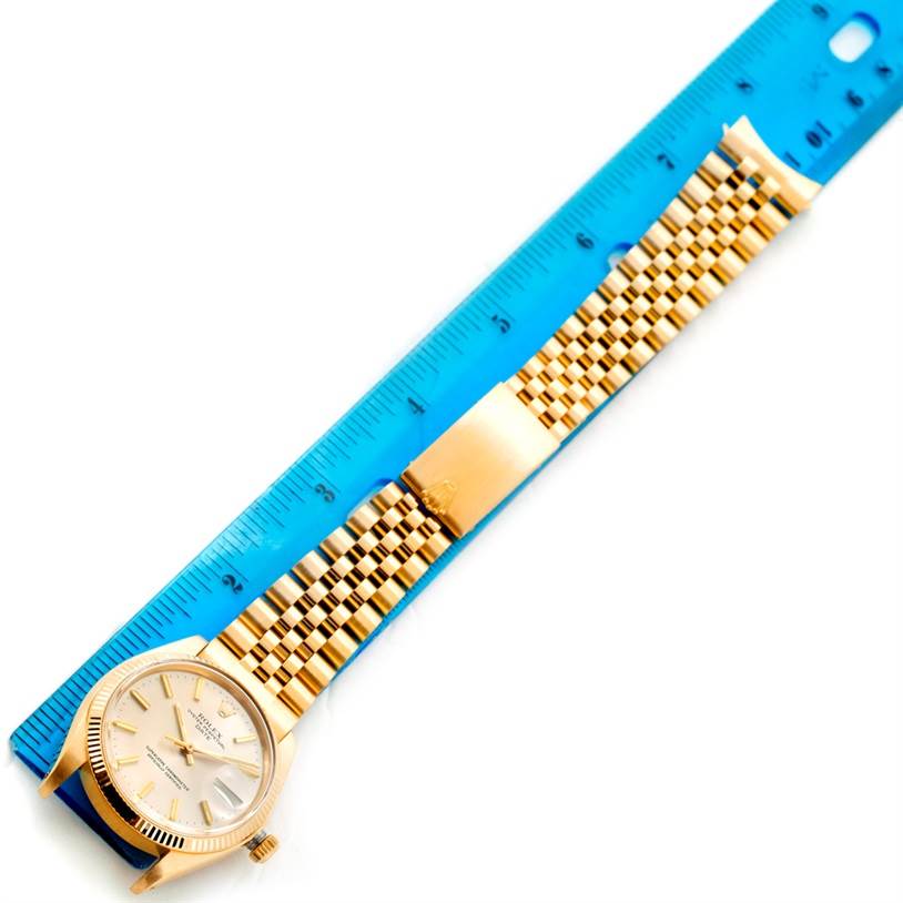 The image shows the Rolex President 1503 Men
s Yellow Gold Silver Dial 1503 Men
s Yellow Gold Silver Dial watch laid flat, displaying the face, bracelet, and clasp alongside a blue ruler.