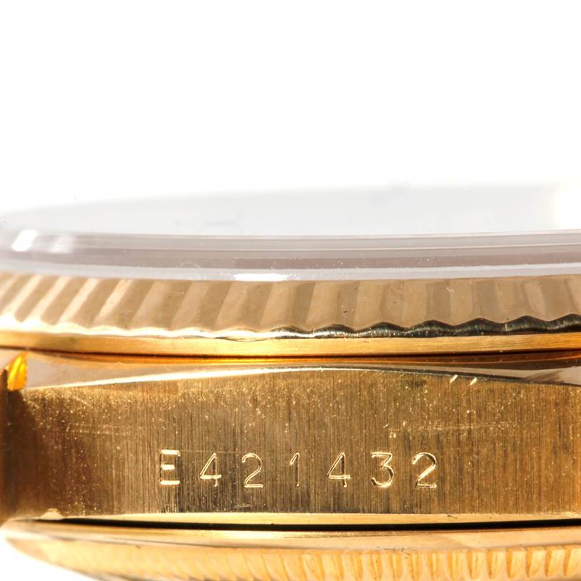 The image shows a side view of the case and bezel of a Rolex President 18238 Men's Yellow Gold White Dial 18238 Men's Yellow Gold White Dial watch, featuring a serial number.
