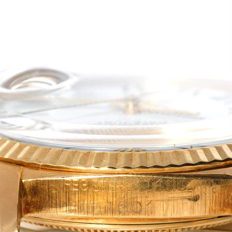 This close-up image of a Rolex President 1601 Men's Yellow Gold White Dial 1601 Men's Yellow Gold White Dial model watch shows the side of the case, bezel, and part of the crystal.