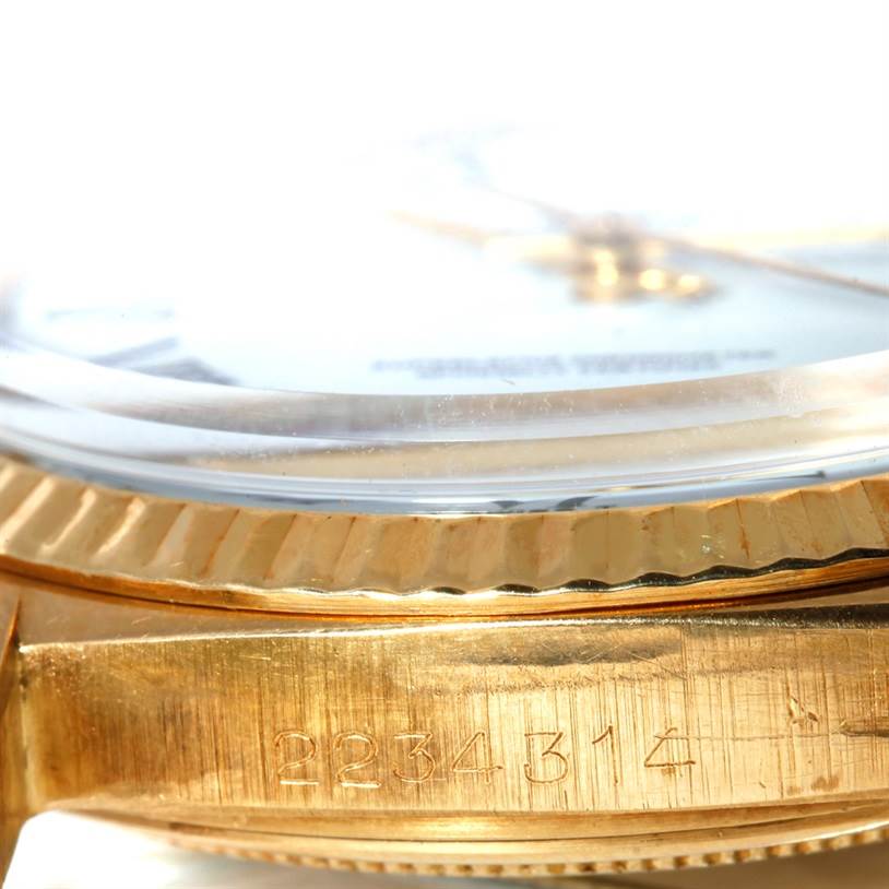 This close-up shows the serial number and part of the bezel and crystal of the Rolex President 1601 Men's Yellow Gold White Dial 1601 Men's Yellow Gold White Dial model watch.
