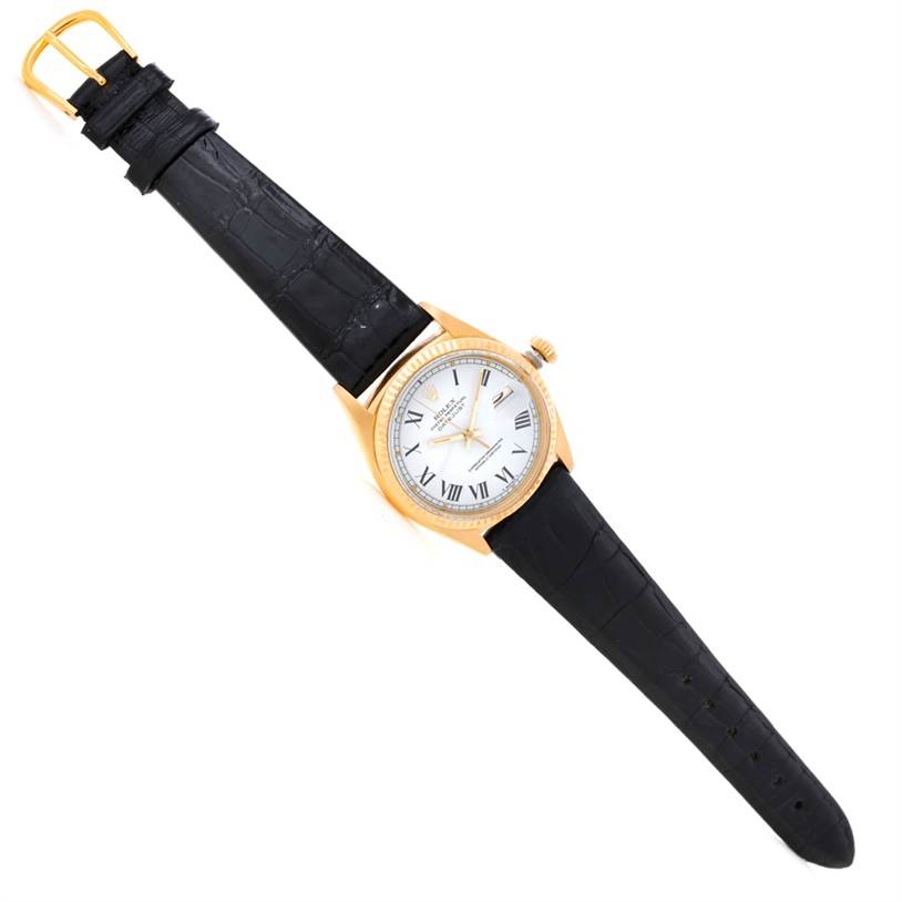 The image shows a Rolex President 1601 Men's Yellow Gold White Dial 1601 Men's Yellow Gold White Dial watch with a black leather strap, white dial, and gold case from an overhead angle.