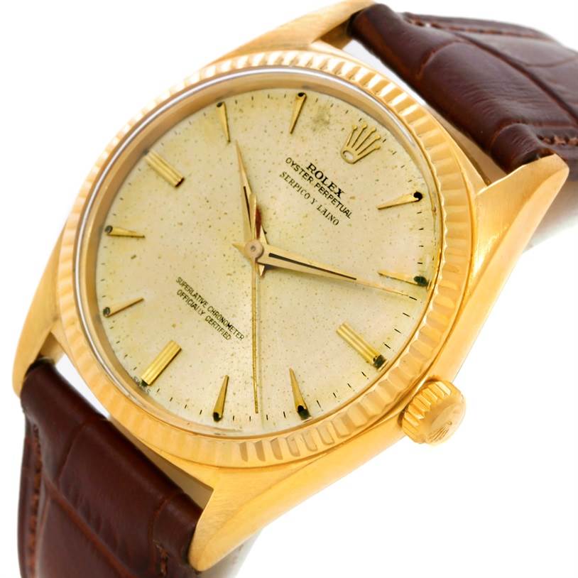 This image shows a Rolex President 1013 Men
s Yellow Gold Champagne Dial 1013 Men
s Yellow Gold Champagne Dial model watch from a tilted front angle, displaying the dial, bezel, and part of the leather strap.