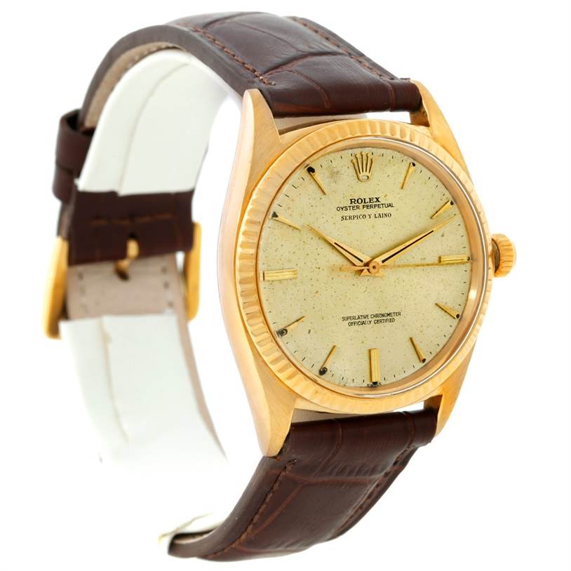 The image shows a Rolex President 1013 Men
s Yellow Gold Champagne Dial 1013 Men
s Yellow Gold Champagne Dial model watch at an angled view, highlighting its gold case, cream dial, and brown leather strap.