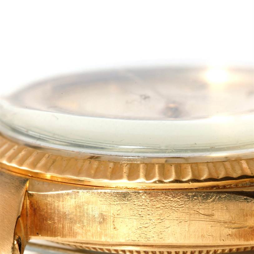 This close-up image shows the side profile of the Rolex President 1013 Men
s Yellow Gold Champagne Dial 1013 Men
s Yellow Gold Champagne Dial model, featuring the watch
s bezel, crystal, and part of the case.